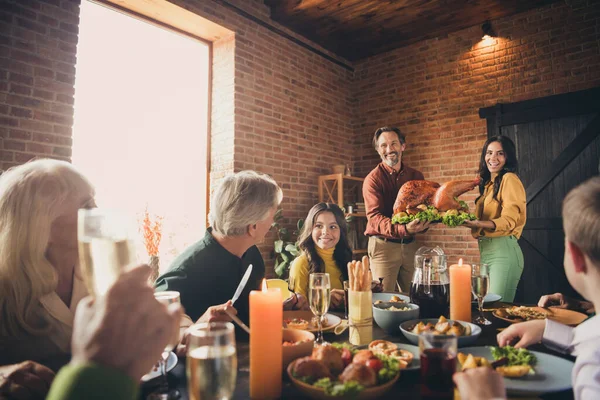 Portrait of nice attractive cheerful family brother sister gathering wife husband carrying plate fresh homemade domestic turkey serving table festive at modern loft industrial brick interior house — Stock Photo, Image