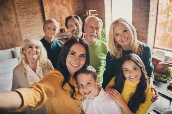 Closeup portrait photo of full big family gathering eight people make selfie cuddle embrace wait pray thank god have good autumn time make wish generation in home evening living room indoors