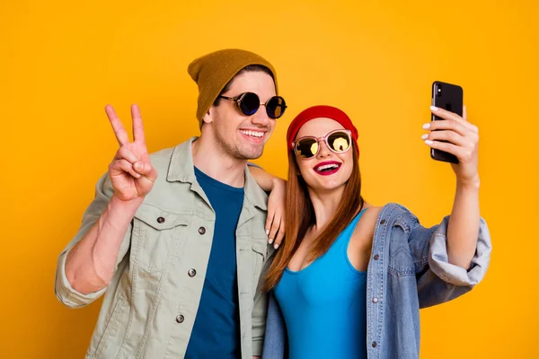 Close-up portrait of his he her she nice attractive glad cheerful cheery couple friends friendship taking selfie showing v-sign isolated over bright vivid shine vibrant yellow color background — Stock Photo, Image