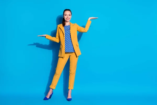 Full length body size view of nice attractive charming chic classy elegant cheerful lady partner leader holding on palms choosing copy space isolated bright vivid shine vibrant blue color background — Stock Photo, Image