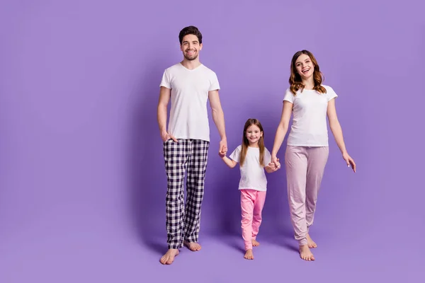 Full length body size view of nice cheerful cheery careful family mommy daddy adopted foster daughter wearing sleepwear bedtime isolated on bright vivid shine vibrant violet color background