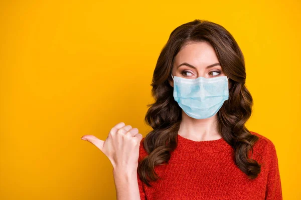 Close-up portrait of her she healthy wavy-haired girl wearing safety gauze mask showing copy space mers cov infection pandemia info poster isolated bright vivid shine vibrant yellow color background — Stock Photo, Image
