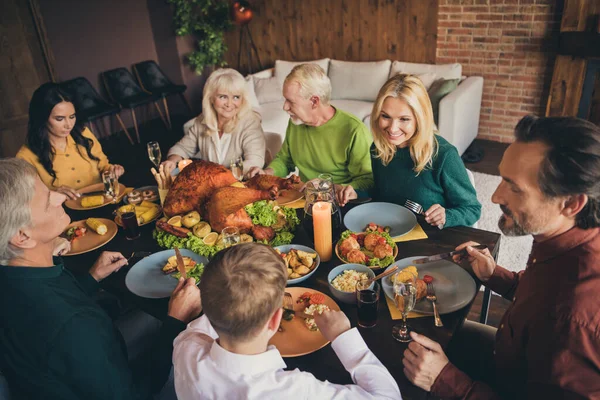 Portrait of nice attractive foster adopted cheerful family meeting eating festal luncheon autumn fall season harvest meal dish turkey celebration at modern loft brick industrial interior — Stock Photo, Image