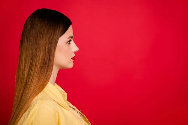 Closeup profile photo of attractive pretty lady bright pomade look side empty space interested not smiling wear casual yellow denim blazer jacket isolated vivid red color background — Stock Photo, Image