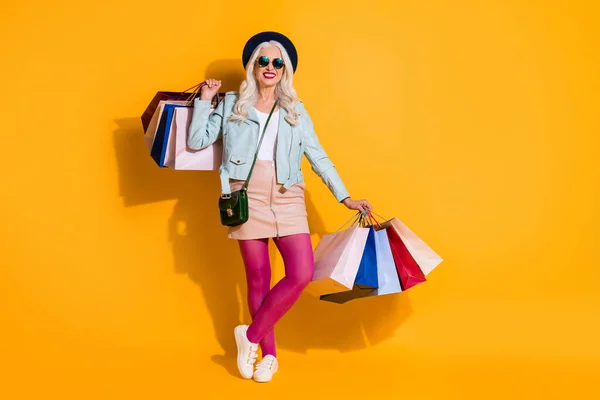 Full length body size of her she nice-looking attractive fashionable cheerful cool gray-haired woman carrying new things clothing center isolated on bright vivid shine vibrant yellow color background — Stock Photo, Image