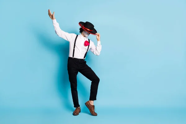 Full length body size view of his he mysterious skinny tall gentleman stranger dancing having fun hiding face behind sombrero ritual cult isolated bright vivid shine vibrant blue color background