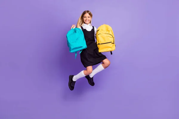 Full length body size view of her she nice attractive cheerful small girl jumping carrying bags autumn season isolated bright vivivid shine vibrant lilac violet purple color background — стоковое фото