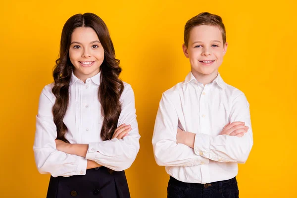 Portrait of her she his he nice attractive cheerful content pupils learners folded arms back new year autumn fall season isolated over bright vivid shine vibrant yellow color background — Stock Photo, Image