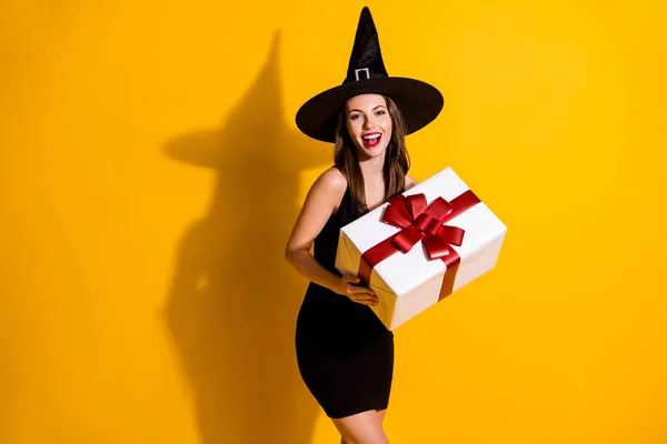 Portrait of her she nice atraktif pretty lovely cheerful cheery lady wizard holding in hands big giftbox congrats chance isolated over bright vivid shine vibrant yellow color background — Stok Foto