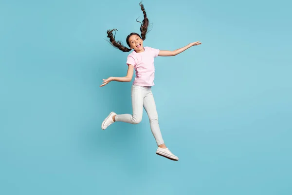 Full length body size view of her she nice attractive pretty funky childish playful comic foolish cheerful cheery girl jumping having fun fooling isolated over blue pastel color background — ストック写真