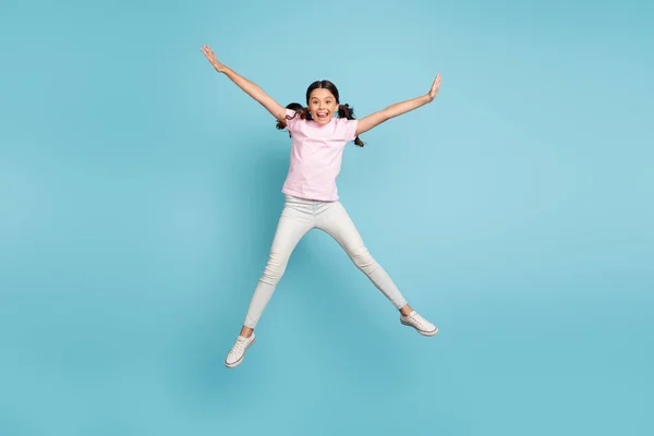 Comprimento total tamanho do corpo vista dela ela agradável atraente muito despreocupado tolo alegre alegre pré-adolescente menina pulando se divertindo enganando isolado sobre azul cor pastel fundo — Fotografia de Stock