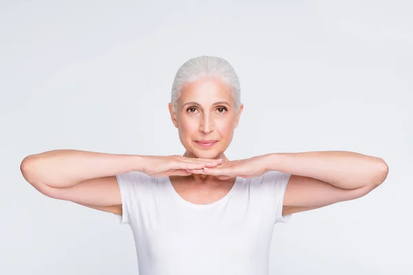 Retrato de agradável atraente linda calma conteúdo tranquilo senhora de cabelos grisalhos mostrando perfeita impecável pele macia eficaz complexo vitamínico orgânico isolado sobre luz branco fundo cinza — Fotografia de Stock