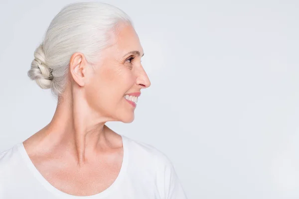 Close-up profile side view portrait of her she nice-looking attractive lovely well-groomed cheerful cheery positive glad gray-haired lady copy space isolated over light white grey pastel background — Stock Photo, Image