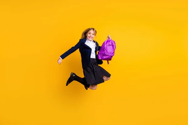 Full length body size view of nice small little cheerful excited girl jumping having fun vacation pass exam examination test isolated bright vivid shine vibrant yellow color background — Stock Photo, Image