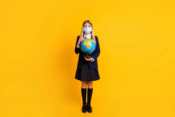 Full length body size view of her she nice attractive smart clever healthy long-haired girl holding in hand globe wearing gauze mask isolated bright vivid shine vibrant yellow color background — Stock Photo, Image