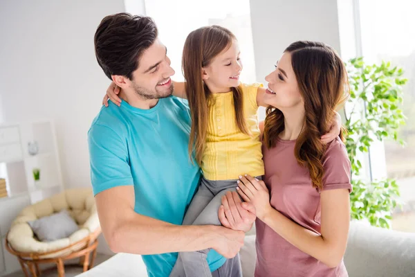 Family portrait of idyllic mom dad cuddle carry embrace small kid girl look bonding love in house indoors — Stock Photo, Image