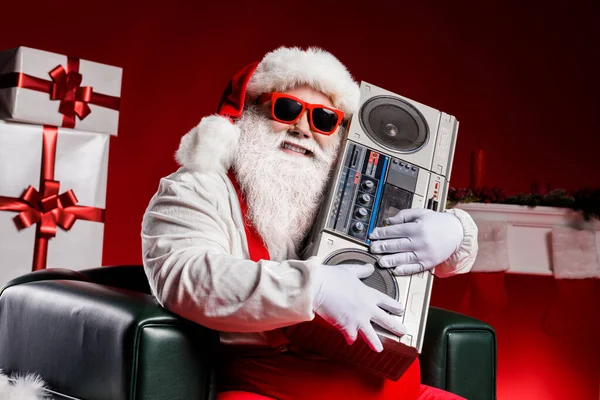 Crazy hipster santa claus hug boom box in x-mas decorated fireplace ornament gift box stockings isolated bright shine color background — Stock Photo, Image