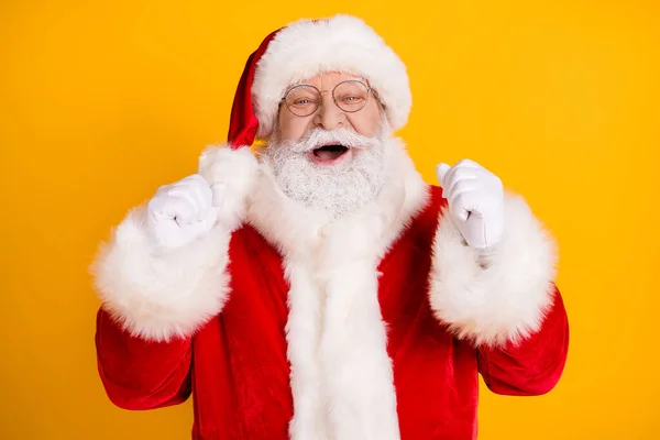 Фото восторженного Санта-Клауса поднять кулаки пользуются Рождество Новый год Холли волшебное чудо лотереи выиграть поднять кулаки носить красную шляпу головной убор изолированы на яркий цвет фона — стоковое фото