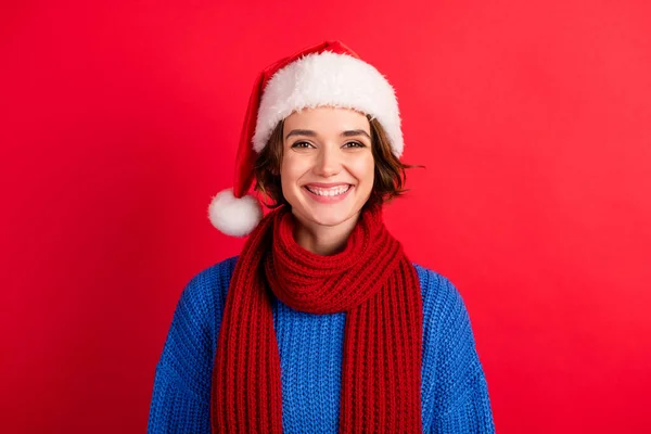 Portrait of charming girl in santa claus headwear look good in camera enjoy newyear tradition party event isolated over vivid red color background — Stok Foto