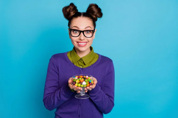 Close-up portrait of her she nice attractive girlish hungry cheerful cheery girl holding in hands bowl caramel candy isolated on bright vivid shine vibrant blue green teal turquoise color background — Stock Photo, Image