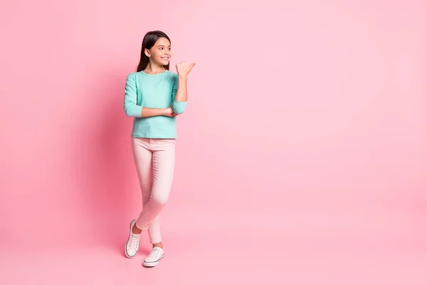 stock image Full length body size photo of pretty small latin girl pointing with finger on blank space smiling isolated on pink color background