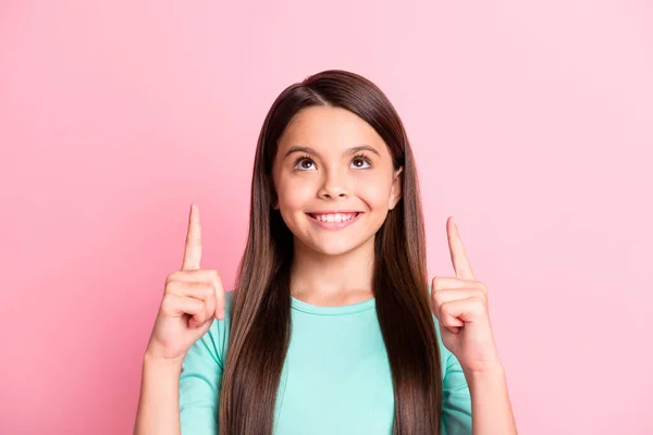 Photo of cute pretty small funny hispanic lady long hairstyle direct indicate forefinger look up empty space toothy smile wear turquoise sweatshirt isolated pink color background — Stock Photo, Image
