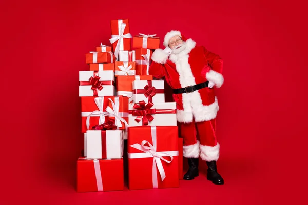 全身上下尽收眼底，看到他美丽俊俏、欢快的圣诞老人圣尼古拉斯站在盛宴堆栈旁，送给北极送货上门的礼物，色彩艳丽鲜红，色彩艳丽 — 图库照片