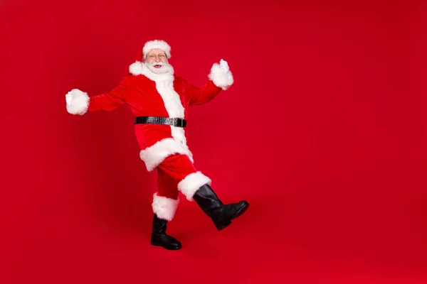 Full length body size view of his he nice attractive handsome cheerful cheery Santa dancing having fun grimacing isolated bright vivid shine vibrant red color background — стоковое фото