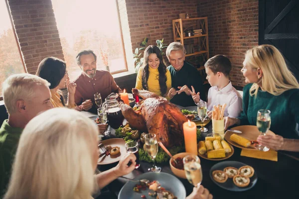 Portrait of nice attractive cheerful cheery positive family parents grandparents meeting gathering eating enjoying tasty yummy festal meal having fun at modern loft brick industrial interior — Stock Photo, Image