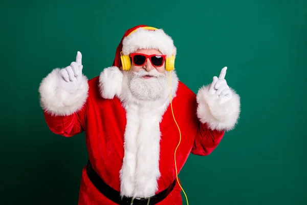 Portret van hem hij mooi aantrekkelijk knap vrolijk cool grappig Santa vader luisteren pop muziek bas single melodie hit met plezier ritme partij geïsoleerd over groene kleur achtergrond — Stockfoto