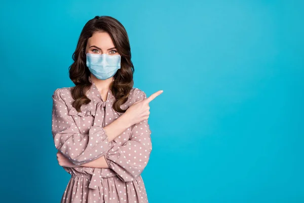 Portret van meisje promotor punt vinger copyspace aanwezig covid nieuws demonstreren advies keuze keuze oplossing dragen medisch masker goed kijken kleding geïsoleerde blauwe kleur achtergrond — Stockfoto