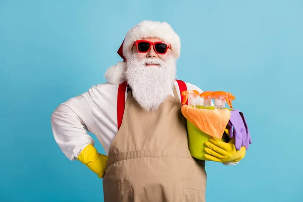 stock image Photo of retired grandfather grey beard hold bucket cleaning equipment prepare disinfect home confident wear santa x-mas costume rubber glove sunglass cap isolated blue color background