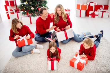 Photo of full big family five people meeting three small kids lie floor carpet unboxing presents wear red jumper jeans in decorated living room x-mas tree many boxes lights indoors clipart