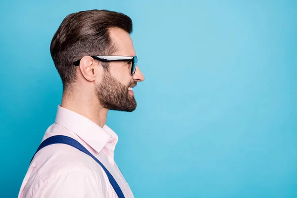 Closeup profile photo of handsome business man successful young chief boss worker look empty space beaming smile wear specs pink shirt suspenders isolated pastel blue color background — Stock Photo, Image