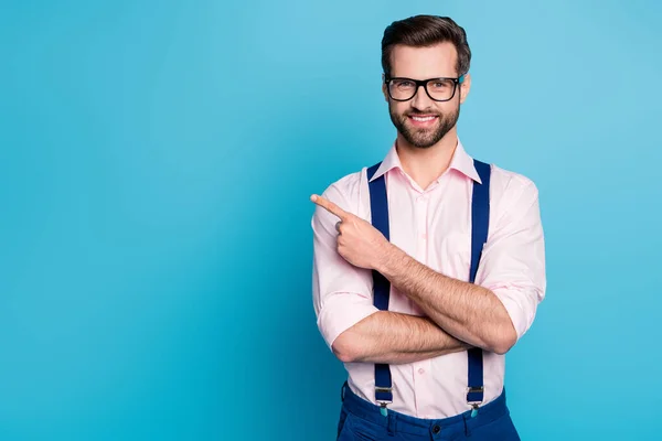Photo of handsome business man good mood trend clothes guy beaming smile eyesight vision specs direct finger side empty space wear pink shirt suspenders isolated blue color background — Stock Photo, Image