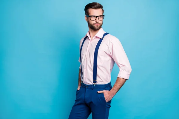 Photo of handsome macho business man cool clothes guy eyesight care vision specs look side empty space wear pink shirt suspenders pants isolated pastel blue color background — Stock Photo, Image
