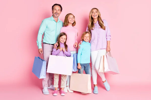 Teljes méretű fénykép nagy család anya anya anya apa apa kisgyerekek van szabad ideje menni sétálni bevásárlóközpont vásárolni hold táskák elszigetelt felett pasztell szín háttér — Stock Fotó