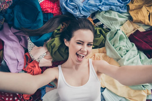 High angle top above closeup photo of nice lady home spring cleaning household lying clothes stack make blog selfies surrounded dirty stuff show followers her closet wink eye flirty indoors — Stock Photo, Image