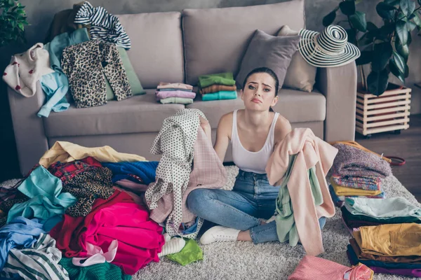 Full length photo of frustrated girl prepare for valentine day party hold dressing have no idea what wear sigh cry sit legs crossed folded floor carpet in house indoors — Stock Photo, Image
