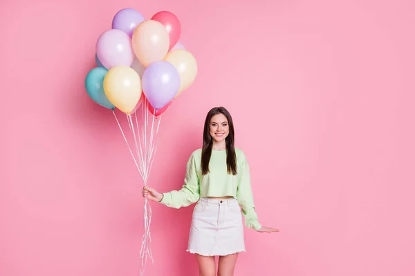 Portret van charmante mooie jeugd meisje houden veel luchtballonnen genieten jubileum evenement dragen goed kijken kleding geïsoleerd over pastel kleur achtergrond — Stockfoto