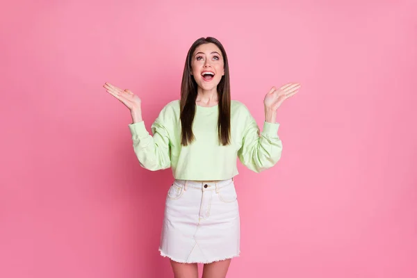 Portrait of astonished funky crazy youth girl look up copyspace impressed wonderful sales discounts scream wear stylish trendy jumper isolated over pastel color background