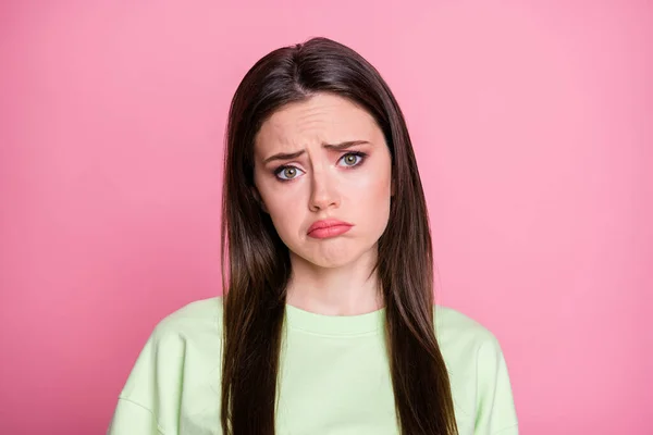Closeup photo of offended depressed lady straight long hairdo look moody disappointed facial expression wear casual green sweatshirt pullover isolated pink pastel color background