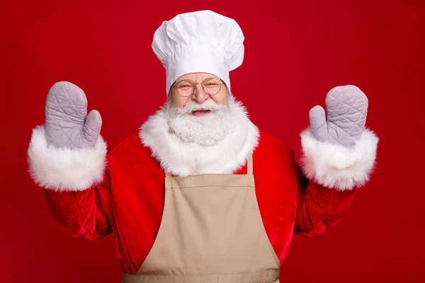 Photo of stylish crazy santa claus x-mas cooking meal wear potholder red costume apron chef cap isolated over bright shine color background — Stock Photo, Image