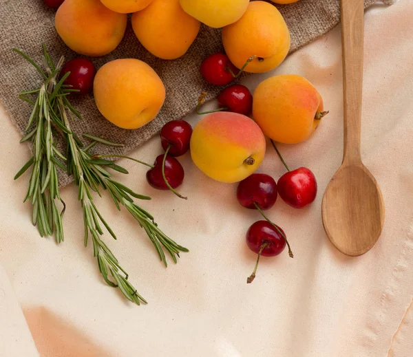 Several Fresh Apricots Cherries Rosemary Wooden Spoon Burlap Sack Background — Stock Photo, Image