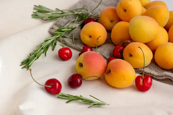 Several Fresh Apricots Cherries Rosemary Wooden Spoon Burlap Sack Background — Stock Photo, Image