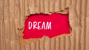 Dream Big message written on ripped torn paper background. Conceptual Dream Big symbol.