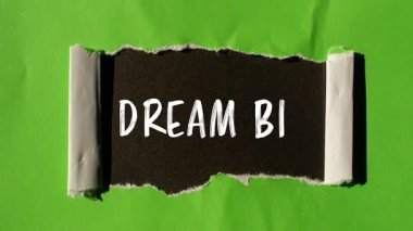 Dream Big message written on ripped torn paper background. Conceptual Dream Big symbol.