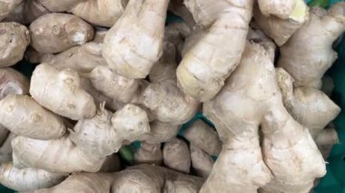 Fresh ginger roots piled in grocery store