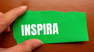 Inspiration message written on ripped torn paper background. Conceptual Inspiration symbol.