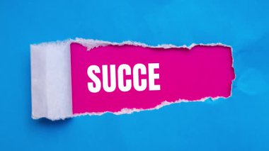 Success message written on ripped torn paper background. Conceptual Success symbol.